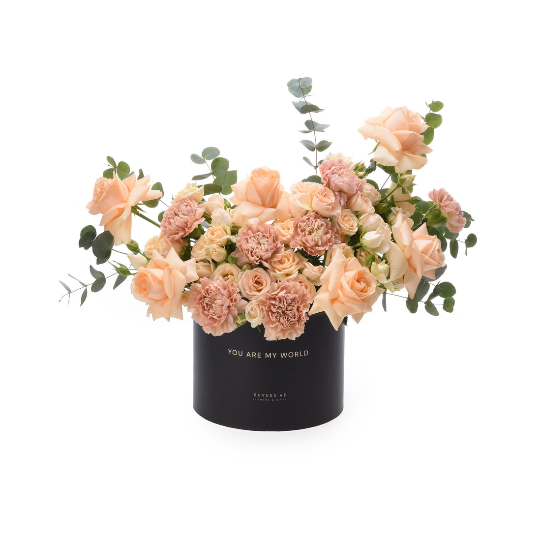 Soft peach roses and carnations in black box with "You Are My World" inscription.