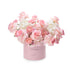 Soft pink roses and hydrangeas bloom in a pastel pink box reading "IT&