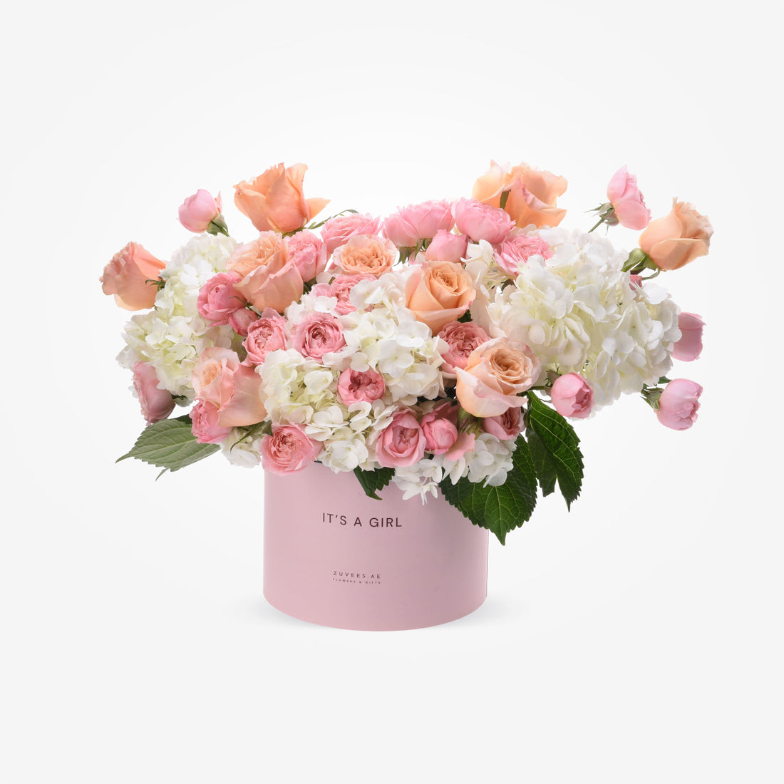 Soft pink and peach roses with white hydrangeas in a pastel pink box reading "IT&