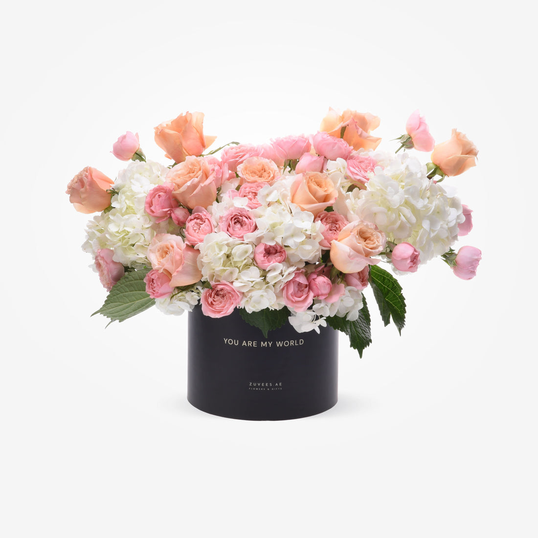 Soft pink roses and white hydrangeas in black box with "You Are My World" inscription.