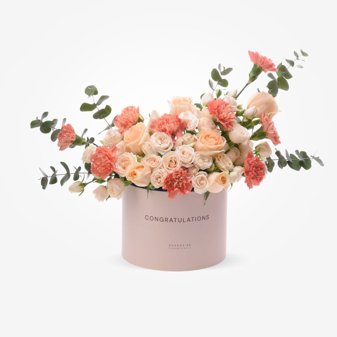 Soft pink box with “CONGRATULATIONS” text, holding peach roses and carnations with eucalyptus.