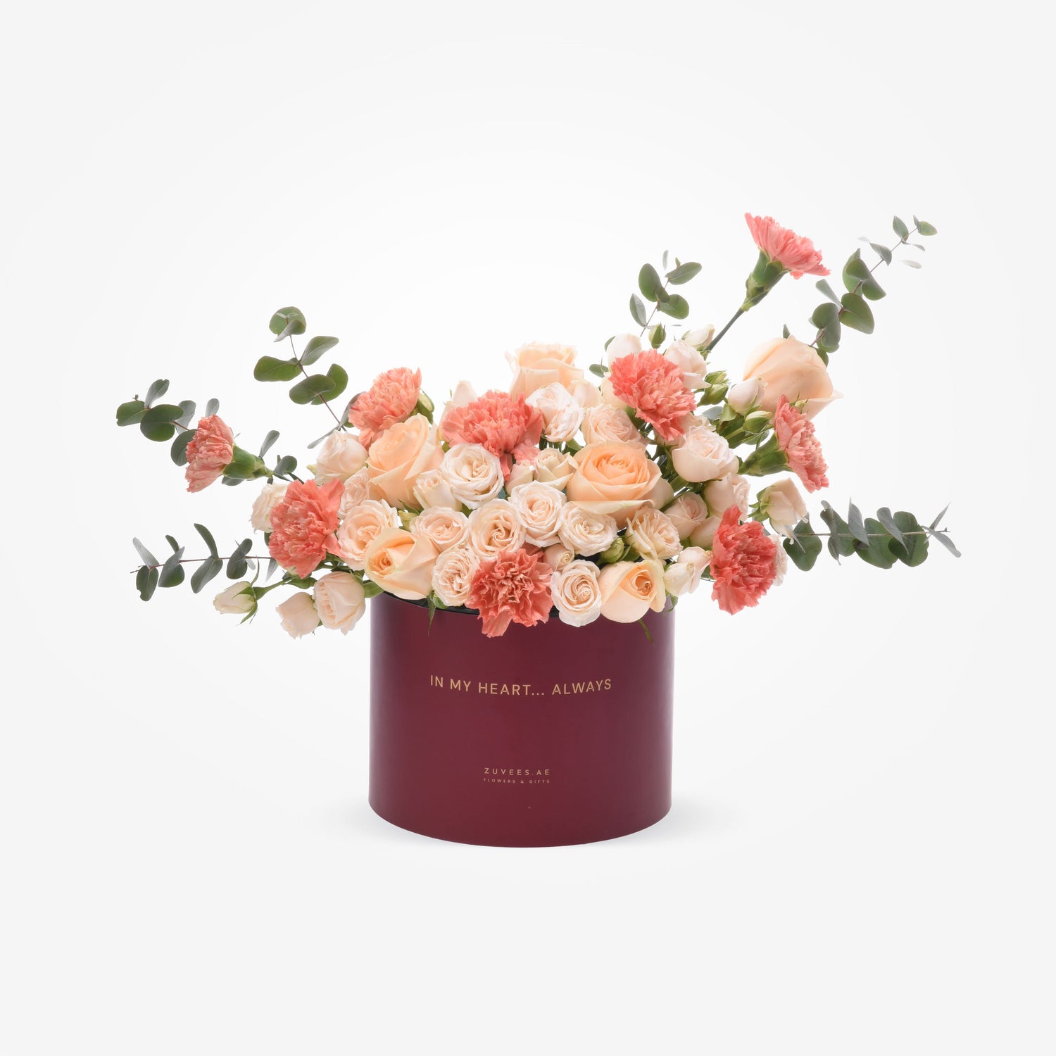 Elegant peach roses and coral carnations in deep burgundy "In My Heart... Always" box.